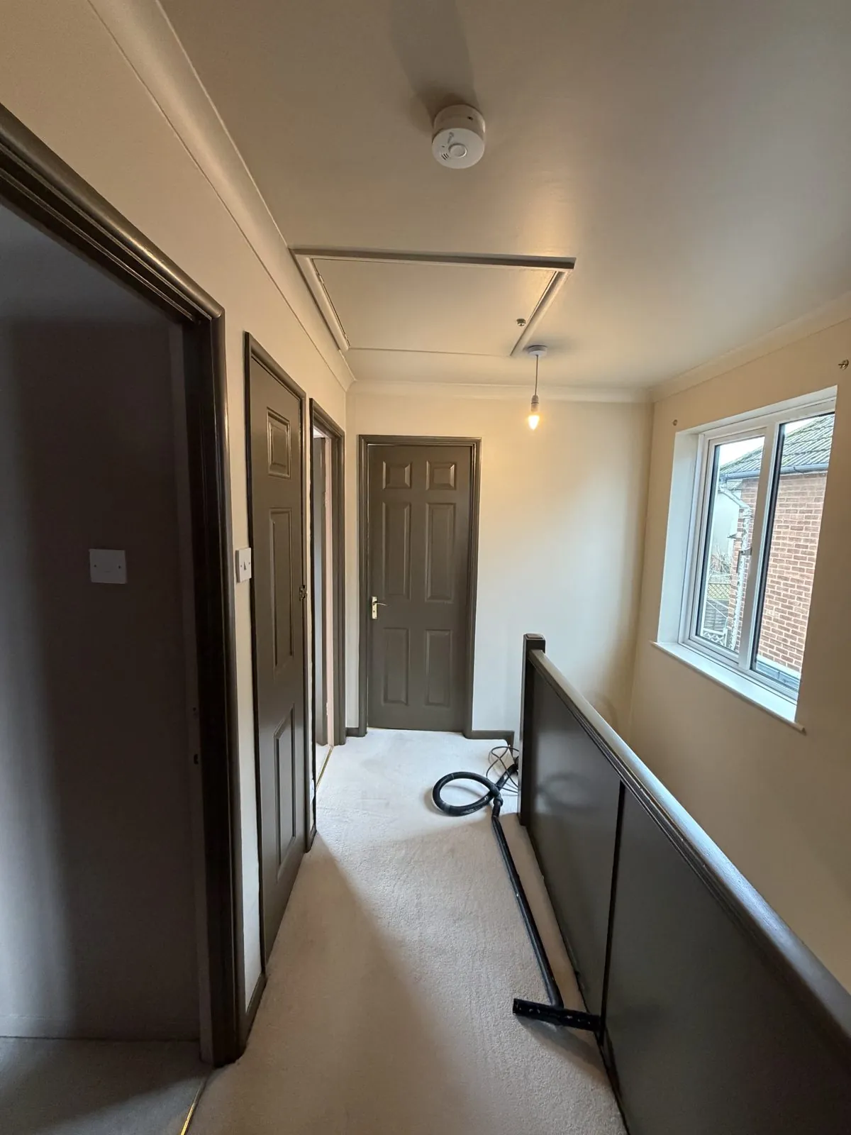 Hallway with painted dark doors