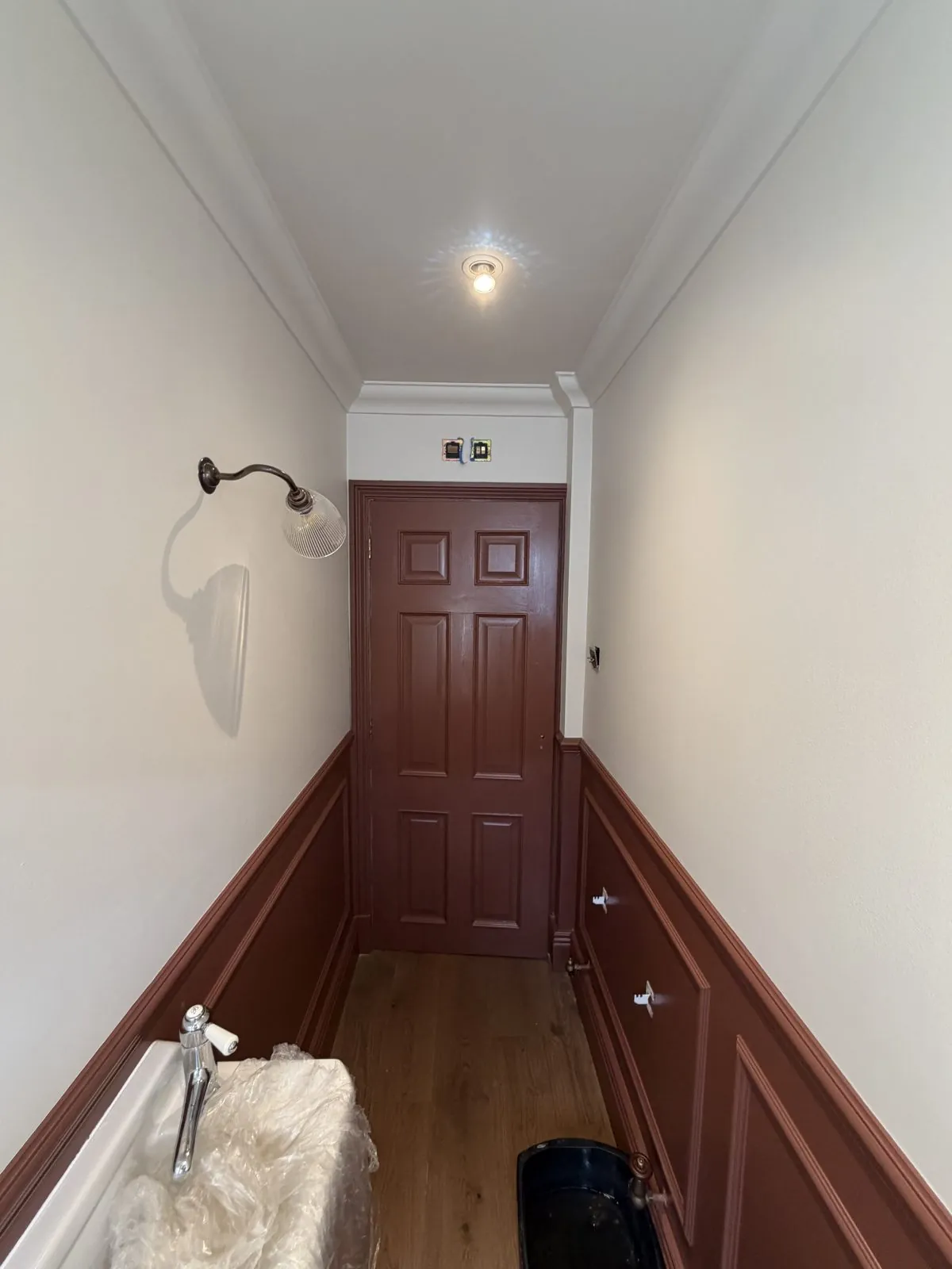 Oxblood panelled hallway